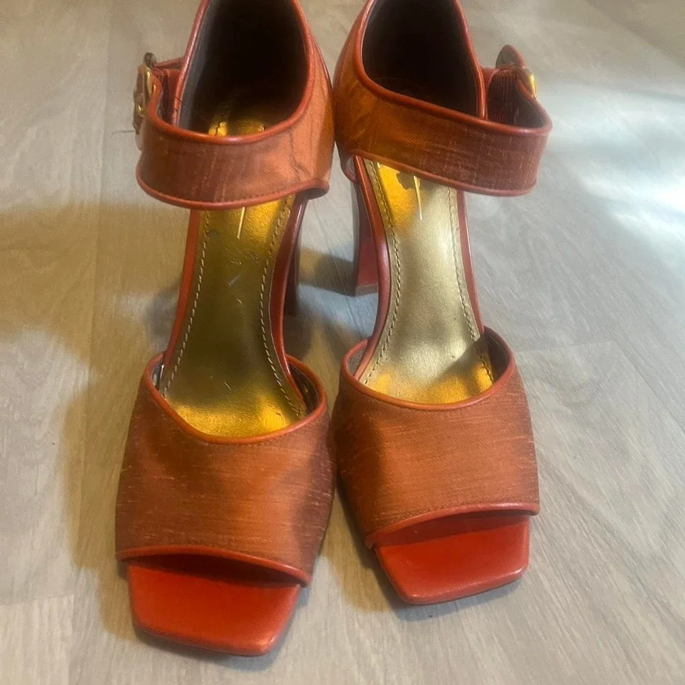 Paleo orange leather heels with gold buckle
